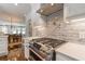 Chef's kitchen featuring gas range, stainless appliances, and white brick backsplash at 2406 Glenwood Ne Dr, Atlanta, GA 30305