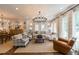Spacious living room featuring a beautiful chandelier, large windows, and comfortable seating at 2406 Glenwood Ne Dr, Atlanta, GA 30305