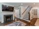 Spacious living room with a fireplace, hardwood floors, and staircase, offering a comfortable and inviting atmosphere at 2406 Glenwood Ne Dr, Atlanta, GA 30305