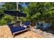Comfortable lounge chairs shaded by a blue umbrella offer a relaxing space on the brick patio at 2406 Glenwood Ne Dr, Atlanta, GA 30305