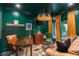 Stylish home office with emerald green walls, wood accents, and comfortable seating at 2406 Glenwood Ne Dr, Atlanta, GA 30305