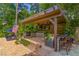 Inviting outdoor kitchen with stone counters, built-in grill, TV, a lounge chair, and ample seating at 2406 Glenwood Ne Dr, Atlanta, GA 30305