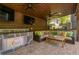 Cozy outdoor kitchen with stone countertops, a built-in grill, a flat-screen TV, and comfortable seating at 2406 Glenwood Ne Dr, Atlanta, GA 30305