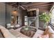 Cozy screened porch with a stone fireplace, ceiling fan, plush seating, and wooded views at 2406 Glenwood Ne Dr, Atlanta, GA 30305