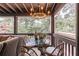 Relaxing screened-in porch with wicker furniture, outdoor lighting, and a view of the surrounding trees at 2406 Glenwood Ne Dr, Atlanta, GA 30305