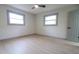 Well-lit bedroom featuring two windows and light-colored wood flooring, creating a comfortable space at 4396 Greenleaf Cir, Atlanta, GA 30331