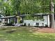 Charming one-story home with a white brick facade, yellow door, and well-maintained landscaped front yard at 4396 Greenleaf Cir, Atlanta, GA 30331