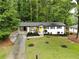 Charming single-story home with manicured lawn, yellow front door, and driveway at 4396 Greenleaf Cir, Atlanta, GA 30331