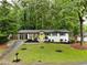 Charming ranch-style home with a well-manicured front yard and a bright yellow front door at 4396 Greenleaf Cir, Atlanta, GA 30331
