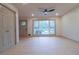 Bright living room featuring a large window with views of the lush yard and a modern ceiling fan at 4396 Greenleaf Cir, Atlanta, GA 30331