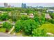 Aerial view of a lush, green neighborhood with mature trees and a skyline in the distance at 5785 Timberlane Ter, Sandy Springs, GA 30328