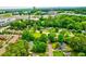 Aerial view showcasing a neighborhood with mature trees, green lawns and a distant skyline at 5785 Timberlane Ter, Sandy Springs, GA 30328