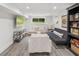 Finished basement area features wood floors, neutral walls, modern furniture, and backyard view at 5785 Timberlane Ter, Sandy Springs, GA 30328