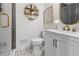 Modern bathroom features decorative tile floors, a glass shower, and a brushed gold faucet at 5785 Timberlane Ter, Sandy Springs, GA 30328