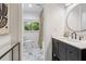 Bathroom with a marble floor, a black vanity, a round mirror, and shower-tub combo at 5785 Timberlane Ter, Sandy Springs, GA 30328