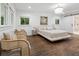 Spacious bedroom features hardwood floors, large windows, and stylish furniture at 5785 Timberlane Ter, Sandy Springs, GA 30328