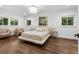 Bright bedroom with hardwood floors, recessed lighting, and comfortable seating area at 5785 Timberlane Ter, Sandy Springs, GA 30328