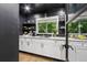 Contemporary butler's pantry with white cabinets, marble countertops, open shelves, and a window with a serene view at 5785 Timberlane Ter, Sandy Springs, GA 30328