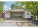 Attached carport offering sheltered parking with an open design and modern white finishes at 5785 Timberlane Ter, Sandy Springs, GA 30328