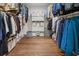 Spacious walk-in closet features hardwood floors, shelving, and ample hanging storage for clothing and accessories at 5785 Timberlane Ter, Sandy Springs, GA 30328