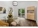 Dining room with wood floors, modern furnishings, large window overlooking lush greenery, and elegant decor at 5785 Timberlane Ter, Sandy Springs, GA 30328