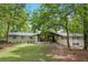 Charming single-story home with a lush lawn, mature trees, and a welcoming front facade at 5785 Timberlane Ter, Sandy Springs, GA 30328