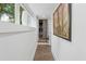 Bright hallway featuring wood-look floors, fresh paint, and artistic touches that enhance the home's modern feel at 5785 Timberlane Ter, Sandy Springs, GA 30328