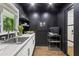 Modern kitchen features a stainless steel sink, white cabinets, and black accent walls at 5785 Timberlane Ter, Sandy Springs, GA 30328