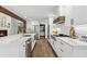 Open-concept kitchen with stainless steel appliances, a large island, and access to the living area with a fireplace at 5785 Timberlane Ter, Sandy Springs, GA 30328
