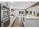 Kitchen features stainless steel appliances, marble countertops, white cabinets, and easy access to the backyard pool at 5785 Timberlane Ter, Sandy Springs, GA 30328