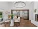 Inviting living room with wood floors, modern lighting, and a comfortable seating area, great for relaxation at 5785 Timberlane Ter, Sandy Springs, GA 30328