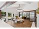 Bright, open living room with wood floors, exposed beams, modern lighting, and access to the pool at 5785 Timberlane Ter, Sandy Springs, GA 30328