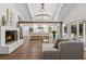 Inviting living room with a fireplace, open to a modern white kitchen with a center island at 5785 Timberlane Ter, Sandy Springs, GA 30328