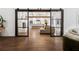 View through sliding doors to an open concept living area with a kitchen and fireplace at 5785 Timberlane Ter, Sandy Springs, GA 30328