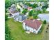 Home with chimney and patio surrounded by trees and lawns from aerial view at 1506 Saint George Pl, Conyers, GA 30012