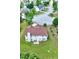 House with beautiful green lawn, chimney, and stone patio from aerial view at 1506 Saint George Pl, Conyers, GA 30012