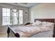 Comfortable bedroom with large window offering natural light and a view of the surrounding neighborhood at 1506 Saint George Pl, Conyers, GA 30012