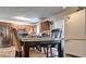 View of dining area featuring modern appliances, kitchen cabinets and dining table at 1506 Saint George Pl, Conyers, GA 30012