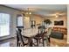 Eat-in kitchen with modern dining table and view into the living room at 1506 Saint George Pl, Conyers, GA 30012