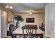 Open dining room featuring stone tile floors, modern light fixtures, and adjacent living area with large TV at 1506 Saint George Pl, Conyers, GA 30012