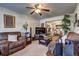 Open-concept living area featuring hardwood floors, comfortable sofas, and adjacent dining space at 1506 Saint George Pl, Conyers, GA 30012