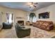 Comfortable living room with a fireplace, plush sofas, and a large TV at 1506 Saint George Pl, Conyers, GA 30012