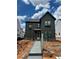 New construction two-story home featuring board siding, black window frames, and a sidewalk leading to the front door at 3472 Adler Trl, Buford, GA 30519