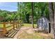 View of the backyard with wood fence, tool shed and lots of mature trees at 4124 Dunnington Dr, Marietta, GA 30062