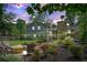 Relaxing backyard space featuring an outdoor fire pit, string lights, and mature landscaping at 4124 Dunnington Dr, Marietta, GA 30062