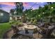 Outdoor entertainment space with stone fireplace, string lights, and cozy seating area at 4124 Dunnington Dr, Marietta, GA 30062