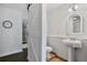 Charming bathroom with pedestal sink, decorative mirror, and a modern sliding barn door at 4124 Dunnington Dr, Marietta, GA 30062