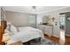 Bright bedroom with hardwood floors, white comforter, shuttered windows, and a view to the ensuite bathroom at 4124 Dunnington Dr, Marietta, GA 30062