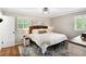 Cozy bedroom with a queen bed, area rug, and natural light from the shuttered windows at 4124 Dunnington Dr, Marietta, GA 30062
