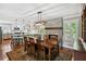 Well-lit dining area featuring a stone fireplace and views into the kitchen and backyard at 4124 Dunnington Dr, Marietta, GA 30062